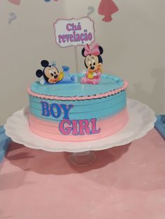 a birthday cake for a boy and girl with mickey and minnie mouse figures on top