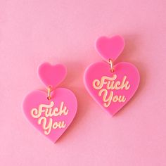 On a pink background is a hot pink pair of heart shaped earrings with ivory Fuck You on each heart. Trendy Pink Heart Earrings, Candy Heart Earrings, Valentines Accessories, Uncut Gems, Polymer Clay Designs, Valentine Earrings, Playful Jewelry, Pink Punk, Clay Designs