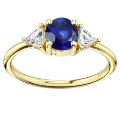 METAL SPECIFICATIONS Yellow Gold 14K STONE SPECIFICATIONS Stone Name : Blue Sapphire and Diamond Stone Cut : Round and Trillion Stone Details : There is one round cut sapphire approx. 1.50 carats (Approx. Dia 6.5 mm) and two trillion diamonds approx. 0.25 carats each (Approx. Size 4.2 x 4.2 x 4.2 mm) on the sides. Natural earth mined stones. Color : F Clarity : VS1 Quality of Sapphire : AAA Sapphire Treatment : Heated Total : Approx. 2 Carats RING SPECIFICATIONS Size : 6.5 (Can ship in any size, 2 Carat Ring, Trillion Diamonds, Ceylon Sapphire, Sapphire Diamond Ring, Natural Earth, Stone Cuts, 2 Carat, Sapphire Diamond, Diamond Stone