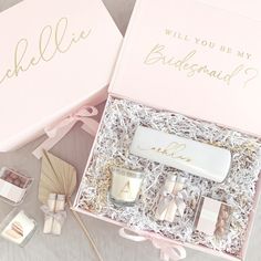 the bridesmaid gift set is in its pink box