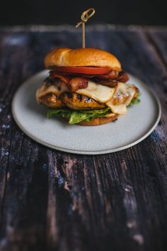 a bacon and apple sandwich on a plate with a toothpick in the middle