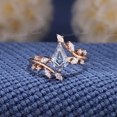 a diamond ring sitting on top of a blue blanket