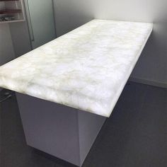 a white counter top sitting inside of a bathroom