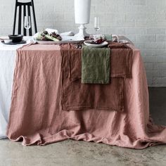 a table topped with plates and bowls of food