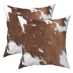 two brown and white cow hide pillows