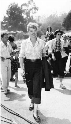 black and white photograph of woman walking down the street