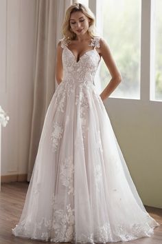 a woman standing in front of a window wearing a wedding dress with flowers on it