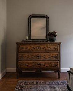 a dresser with a mirror on top of it