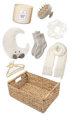 an assortment of baby items including socks, scarves and mittens in wicker basket