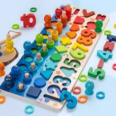 an assortment of wooden toys and numbers on a table