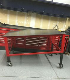 a red workbench sitting on top of a metal table