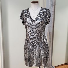 Parker Serena Sequin Beaded Embellished Silk V-Neck Mini Dress Color: Silver & Black Size: 6 (Runs A Little Small, Fits More Like A 4) Condition: New With Tags! Retail: $460 70% Off *Has A Few Loose Threads Here & There Extra Beads & Sequins Included Low V-Neck Short Sleeves Slim Fit Sheath Dress Mini Length Black Silk With Allover Heavy Silver Sequin And Bead Embellishments In An Art Deco Pattern This Dress Has Some Weight To It! Zip & Hook Closure At Back Fully Lined In Smooth Black Satin Perfect For Special Occasions, Wedding, Holiday Party, New Year's Eve, Or Black Tie Event. Material: 100% Silk Lining Is 100% Polyester Measures: 33" Bust, 28" Waist, 38" Hip, 33.5" Length, 5" Silver Embellished V-neck Mini Dress, Fitted V-neck Sequin Dress For Festive Occasions, Silver V-neck Mini Dress For Wedding, Silver V-neck Cocktail Dress, V-neck Embellished Sequin Dress For Festive Occasions, Silver V-neck Holiday Dresses, Silver Short Sleeve Dress For Night Out, Festive Embellished V-neck Sequin Dress, Festive V-neck Embellished Sequin Dress