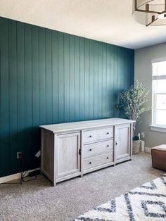 a living room with green walls and white furniture