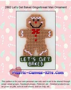 a cross stitch gingerbread man ornament on a pink background