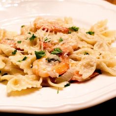 pasta with shrimp and parmesan cheese on a white plate