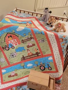 two stuffed animals sitting on top of a bed next to a toy truck and farm scene