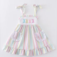 Hop Into Style With This Adorable Multicolored Stripe Bunny Embroidery Smocked Girl’s Dress. Perfect For Any Fashion-Forward Little One, This Set Boasts A Playful Design And Comfortable Fit. Let Your Little Bunny Hop Around In Style And Comfort With This Unique And Fun Ensemble. 95%Cotton 5%Spandex Multicolor Ruffled Dress For Easter, Multicolor Ruffled Easter Dresses, Playful White Embroidered Dress, Playful Pink Embroidered Dresses, Multicolor Cotton Dress For Easter, Sweet Embroidered Cotton Dress, White Sleeveless Easter Dress, Sweet White Easter Dress, Sweet White Easter Dresses