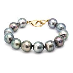 A stunning selection of twelve round Tahitian Pearls circle the wrist for a stunning statement and close with a 18k Yellow Gold clasp. Details: Length: 8.75" Pearl Size: 12.4-17 mm Pearls strung with black, handmade twisted White Gold toggle and Diamond tips. Alchemy's Bio & Catalog can be found here. Please contact us for resizing options, special order inquiries, or any other questions. Luxury Tahitian Pearl White Gold Jewelry, Luxury White Gold Tahitian Pearl Jewelry, Classic Tahitian Pearl Jewelry With Round Beads, Classic Jewelry With Hidden Clasp For Gift, Round Tahitian Pearl Jewelry With High Luster, Tahitian Pearl Jewelry With High Luster, Tahitian Pearl Bracelet, Nails Accessories, Expensive Jewelry Luxury