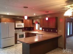 an empty kitchen with wooden cabinets and white refrigerator freezer next to a stove top oven