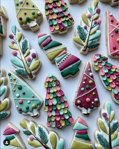 many decorated christmas cookies on a white surface