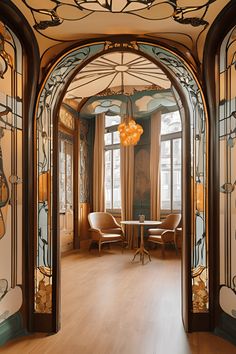 an archway leads into a dining room with chairs and tables in it, along with stained glass windows