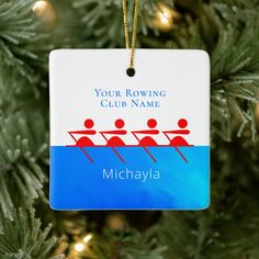 a personalized ornament hanging from a christmas tree with rowing team on it