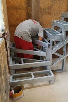 a man is working on some metal steps