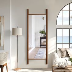 a living room with a large mirror on the wall next to a couch and coffee table