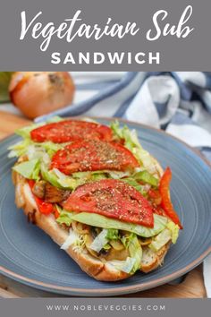 a sandwich with tomatoes and lettuce on it is sitting on a blue plate