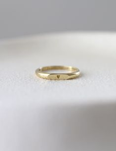 14k solid gold minimalist signet ring with heart. Also ideal as wedding band for her 14k solid yellow gold Width: 2.5 mm | 0.1 inch Packed in labeled gift box Handmade Feel free to contact us for details and special requests All items can be ordered in 14k/18k yellow, white or rose solid gold Please review terms and conditions before checkout For more rings: https://www.etsy.com/shop/YajewelryShop?ref=simple-shop-header-name&listing_id=538123779&section_id=30745115 Gold Band Promise Ring, Yellow Gold Heart Ring, Simple Gold Band Ring, Gold Ring Heart, Simple 14k Gold Engraved Ring For Anniversary, 14k Gold Stackable Rings With Heart Charm For Anniversary, Classic Stackable Heart Promise Ring, 14k Gold Stackable Rings With Heart Charm, Minimalist Heart Shaped Stackable Rings For Anniversary