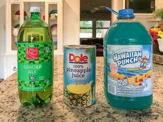 three different types of juice on a kitchen counter