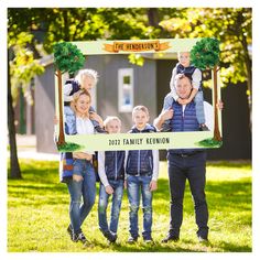 the family is posing for a photo in front of their house