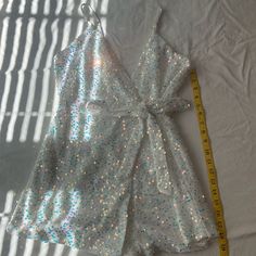 This Is. Beautiful White Sequin Romper By Luxxel! Never Worn, In Mint Condition. Zips In Back, Ties In Front. Straps Are Adjustable As Well. Party White Sequined Jumpsuits And Rompers, White Jumpsuits And Rompers For Party, White Jumpsuits And Rompers For Party Season, V-neck Sequined Jumpsuits And Rompers For Summer, Sequin Rompers, Mint Condition, Pant Jumpsuit, Jumpsuit Romper, Sequin