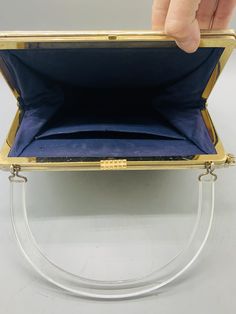 "Vintage Reversible Purse 3 in 1 Needlepoint/ Navy Blue and Black Patent Leather Top Handled Purse The purse measures 8\" tall and the handle adds an additional 5\" 2.5\" wide 9\" long clear lucite handle attached. The purse opens via the latch on top and has an inside pocket The needlepoint cover can detach from the sides revealing a matte navy blue purse, or you can flip the floral side over and attach the patent leather black cover making this purse the only one you'll ever need! SHIPPING est Square Formal Satchel With Detachable Handle, Formal Square Satchel With Detachable Handle, Handheld Clutch With Gold-tone Hardware For Travel, Classic Rectangular Evening Bag With Detachable Handle, Gold Clutch Satchel For Formal Occasions, Gold Square Satchel With Top Carry Handle, Square Formal Bags With Handles, Evening Satchel With Detachable Strap And Rectangular Case, Gold Shoulder Bag With Removable Pouch In Rectangular Case