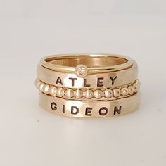 Thick gold filled name rings, 14k gold filled name ring set, chunky name ring set, Mother's ring, stackable name rings These 3mm name rings are handmade in our Indiana studio. Each engraved ring starts from a spool of wire. They are handcut, handformed and soldered in the first process of creating your ring. They are then hammered to size, engraved, handbrushed, and polished. Each ring will have a small solder spot in the back because they are handmade, not machine made. We use yellow gold solder on our yellow and rose gold filled rings because rose gold solder contains carcinogens. The rings are very unique. There may be slight color variations between the solder and the metal on the ring. These rings are individually made for you and no two are alike- they will not fade like plated! Plea Thick Stacking Ring, Mom Rings, Name Rings Silver, Stackable Name Rings, Set Of Rings, Mothers Day Rings, Multiple Rings, Ring Spacer, Gifts Mom