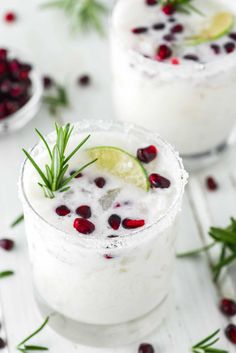 white christmas margarita with lime and cranberries on the rim, garnished with rosemary