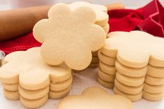 cookies are arranged in the shape of flowers on a table next to cookie cutters