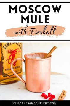 a moscow mule with fireball in it and cinnamon sticks on the table next to it