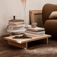 a stack of books sitting on top of a coffee table