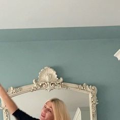 a woman taking a selfie in front of a mirror