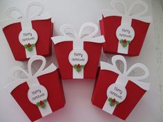 four red gift boxes with white bows and merry christmas tags