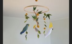 a mobile with birds and flowers hanging from it