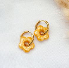 Yellow Resin Flower Charm Huggie Hoop Earrings - Hypoallergenic Stainless Steel, Hypoallergenic Earrings, Handmade Jewelry, Gift For Her Add a touch of charm to your style with these delightful colored resin flower-shaped charm huggie hoop earrings. Each earring features a meticulously crafted flower charm made from high-quality uv resin, suspended from a sleek 19mm stainless steel huggie hoop. The stainless steel hoop offers durability and a hypoallergenic design, making it ideal for those with Hypoallergenic Yellow Hoop Earrings As Gift, Yellow Flower Shaped Hoop Earrings As Gift, Yellow Flower Hoop Earrings For Gift, Hypoallergenic Small Hoop Flower Earrings For Gifts, Hypoallergenic Flower Shaped Hoop Earrings For Gift, Hypoallergenic Small Hoop Flower Earrings As Gift, Yellow Hypoallergenic Hoop Earrings As Gift, Hypoallergenic Yellow Hoop Earrings For Gifts, Hypoallergenic Small Hoop Flower Earrings