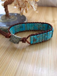 a turquoise beaded bracelet on a wooden table