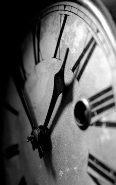 an old clock with roman numerals on it's face is shown in black and white