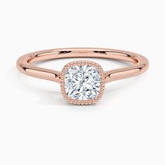 a rose gold engagement ring with a cushion cut diamond in the center