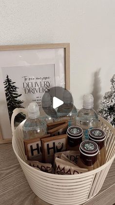 a basket filled with personal care items on top of a wooden table next to a christmas tree