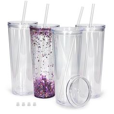 three different colored tumblers with straws in them and one is filled with confetti