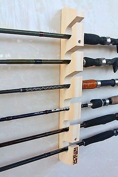 a wall mounted fishing rod rack holds several rods