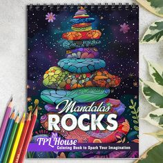 an adult coloring book with colorful rocks on the cover and colored pencils next to it